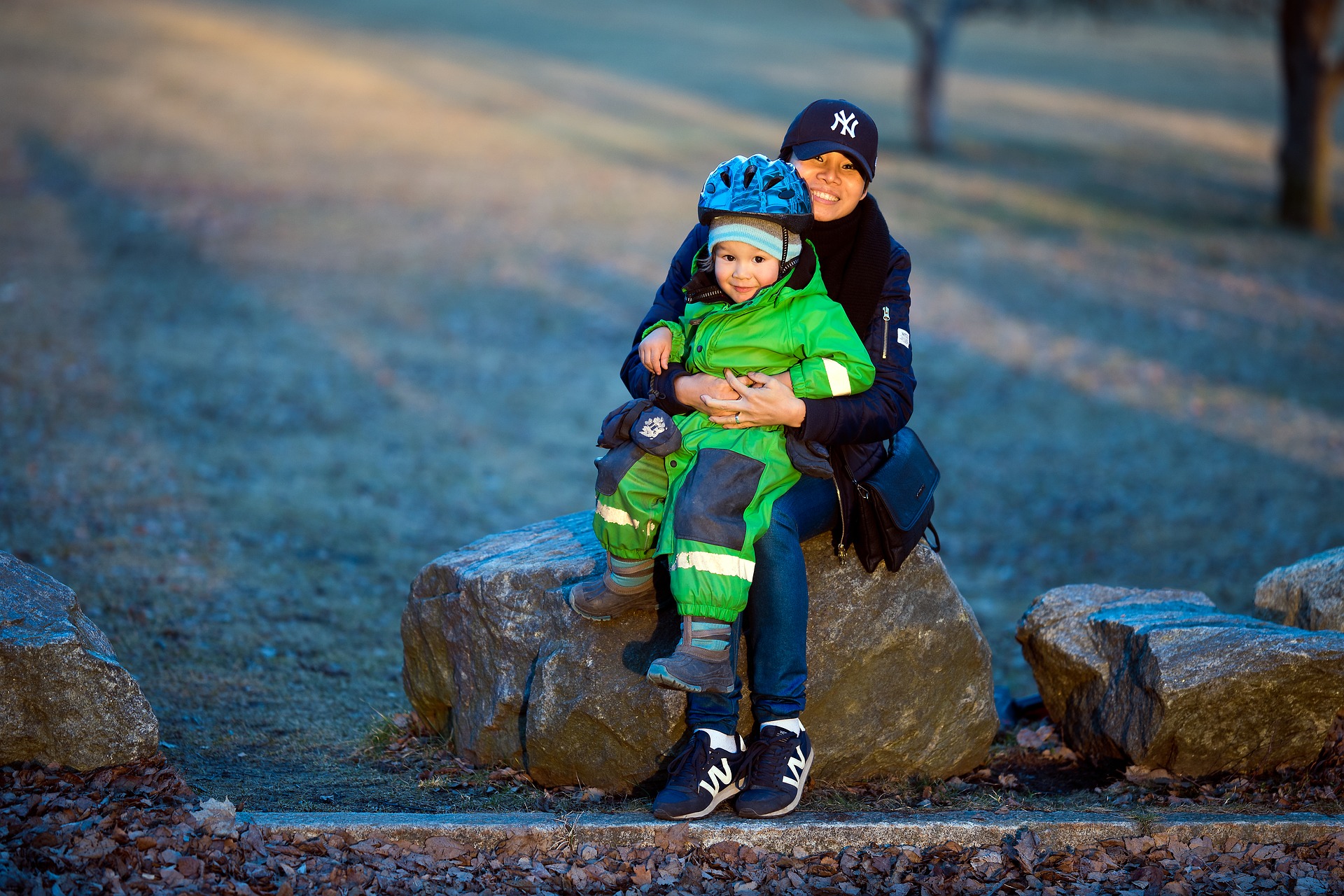 Life Insurance Beyond your employer, mother holding child wearing helmet and pads